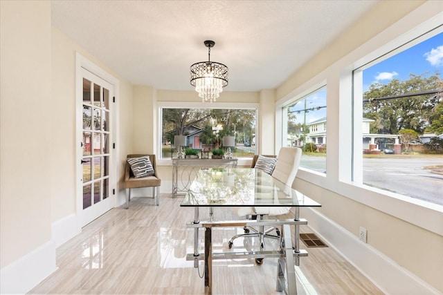 sunroom with a chandelier