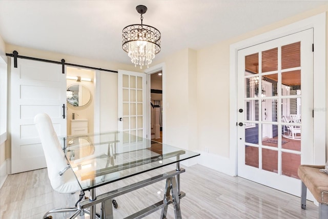 home office featuring french doors, an inviting chandelier, and a barn door