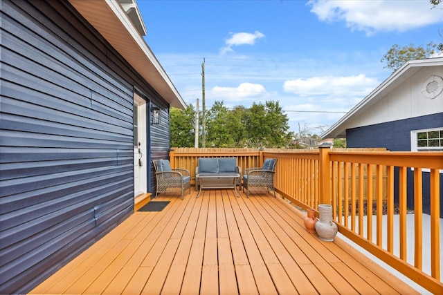 wooden terrace with outdoor lounge area