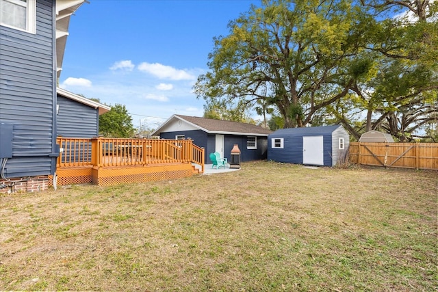 view of yard with a deck and a shed