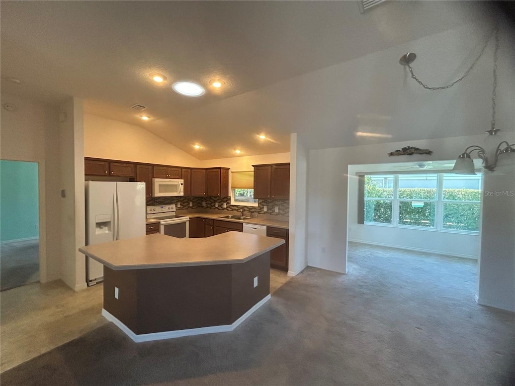 kitchen with tasteful backsplash, light colored carpet, vaulted ceiling, a center island, and white appliances