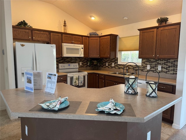 kitchen with light tile patterned floors, a center island, white appliances, lofted ceiling, and sink