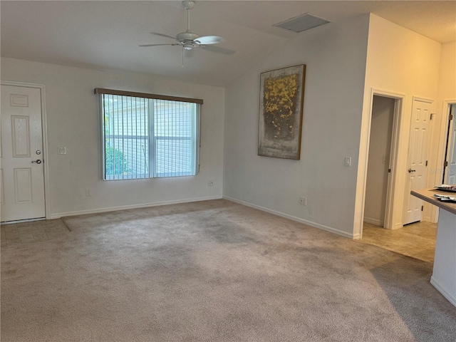 carpeted spare room with vaulted ceiling and ceiling fan