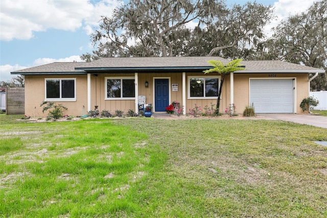 ranch-style home featuring a garage and a front lawn