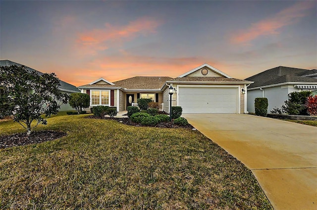 single story home with a garage and a yard