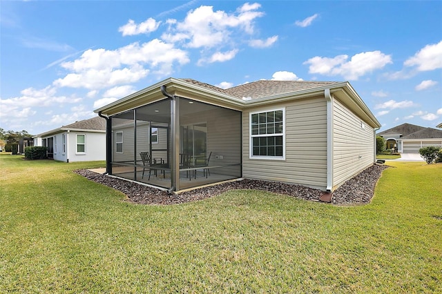 back of property featuring a patio area, a yard, and a sunroom