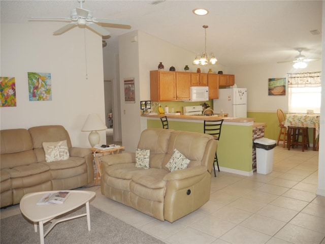 living room with lofted ceiling, light tile patterned flooring, and ceiling fan with notable chandelier