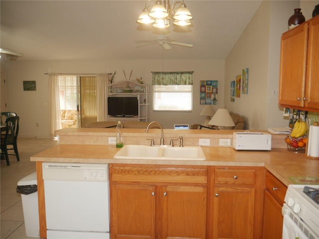 kitchen featuring sink, light tile patterned floors, white appliances, and a wealth of natural light