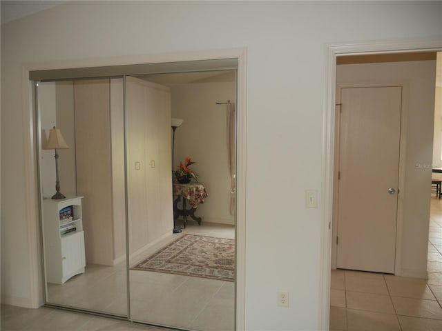 corridor featuring light tile patterned floors