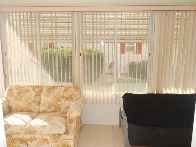 living area featuring a wealth of natural light and light tile patterned floors