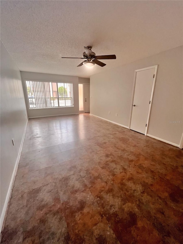 unfurnished room featuring ceiling fan and a textured ceiling