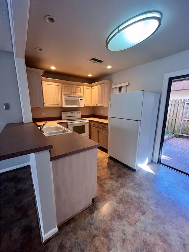 kitchen featuring sink, white appliances, white cabinets, and kitchen peninsula