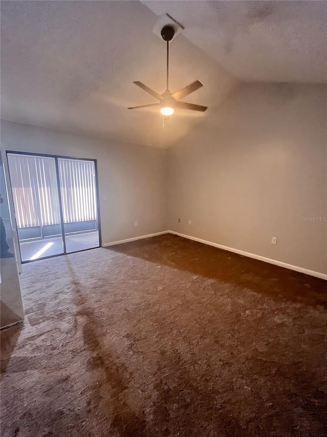 carpeted spare room with ceiling fan, a textured ceiling, and lofted ceiling