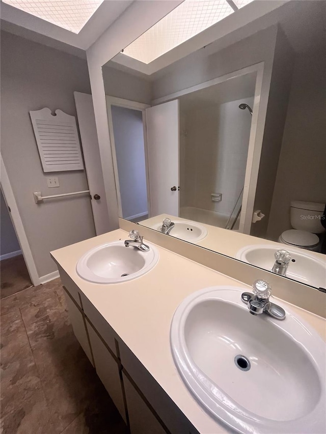 bathroom featuring toilet and vanity