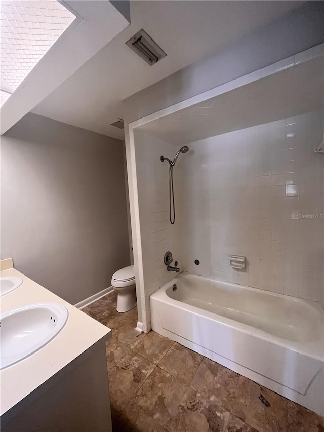 full bathroom featuring toilet, vanity, and tiled shower / bath