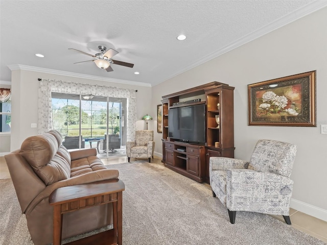 living room featuring ceiling fan, light carpet, ornamental molding, and a textured ceiling