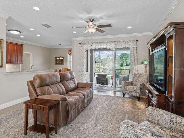 living room with a textured ceiling, ceiling fan, ornamental molding, and light tile patterned floors