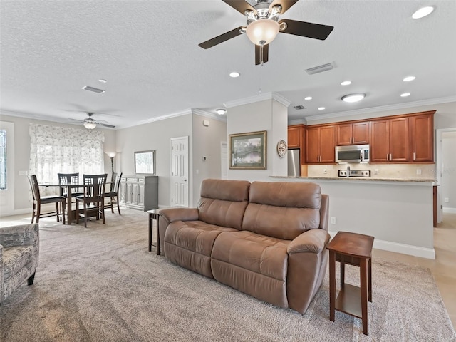 living room with ceiling fan, a textured ceiling, light carpet, and ornamental molding