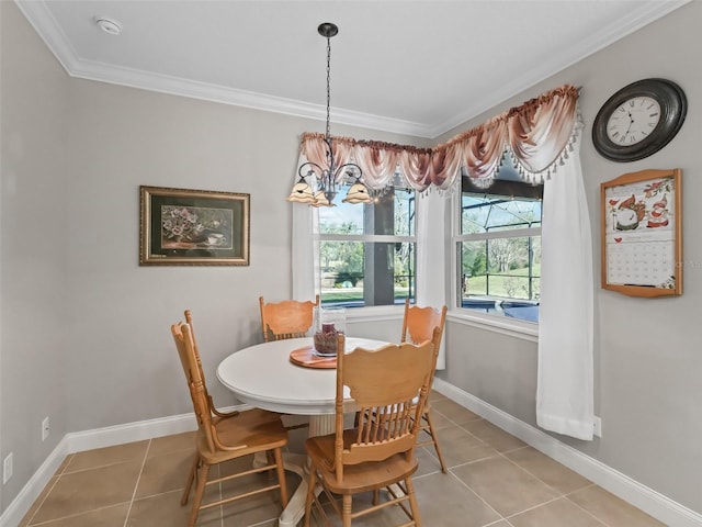 dining space with ornamental molding, a chandelier, and tile patterned flooring