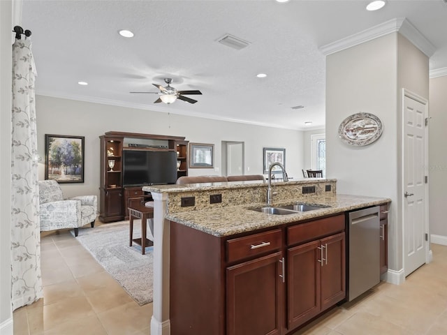 kitchen featuring dishwasher, sink, light tile patterned floors, crown molding, and a breakfast bar area