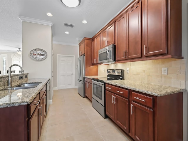 kitchen with light stone countertops, stainless steel appliances, sink, ornamental molding, and light tile patterned flooring