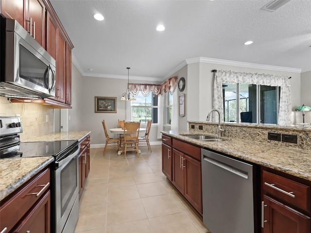 kitchen with light stone countertops, sink, appliances with stainless steel finishes, and crown molding