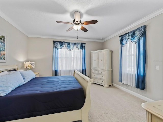 bedroom with ceiling fan, carpet, and crown molding