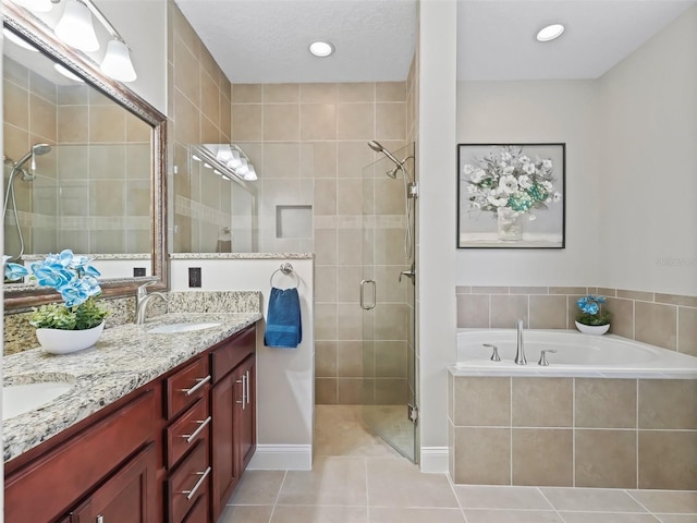 bathroom featuring plus walk in shower, tile patterned flooring, and vanity