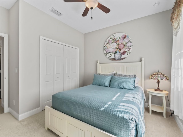 carpeted bedroom featuring ceiling fan and a closet