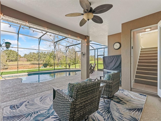 view of patio / terrace featuring a lanai and ceiling fan