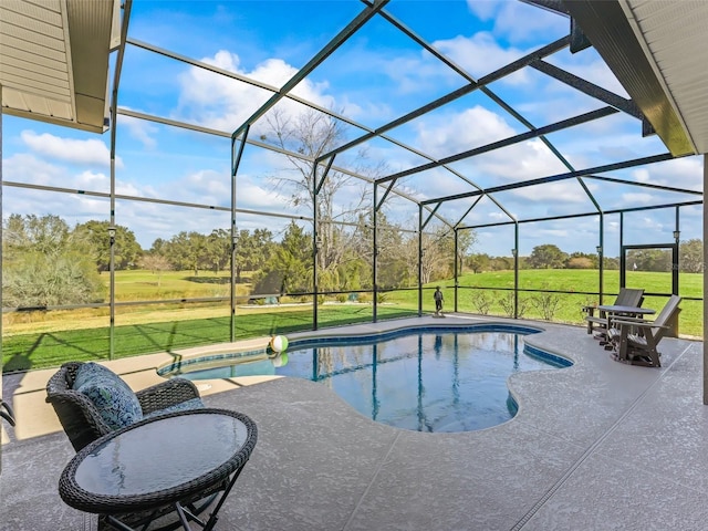 view of pool with a patio area, a lanai, and a lawn