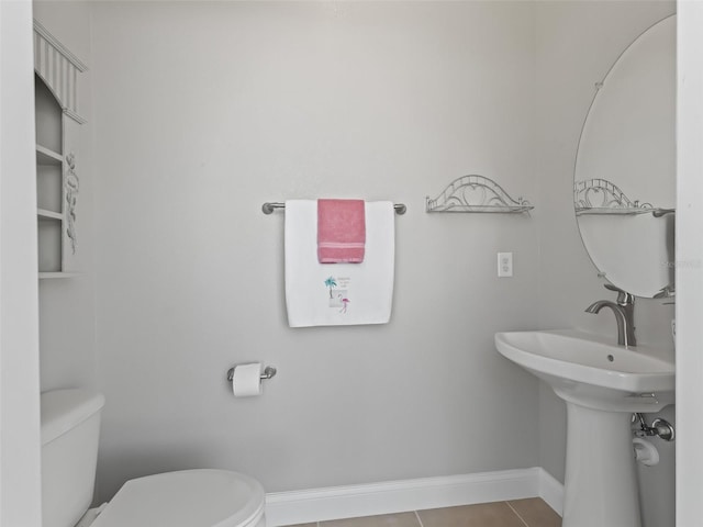 bathroom featuring toilet and tile patterned flooring