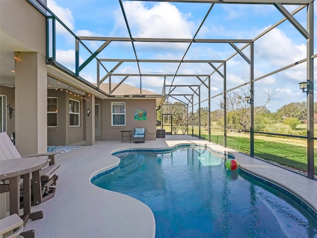 view of swimming pool featuring glass enclosure and a patio area