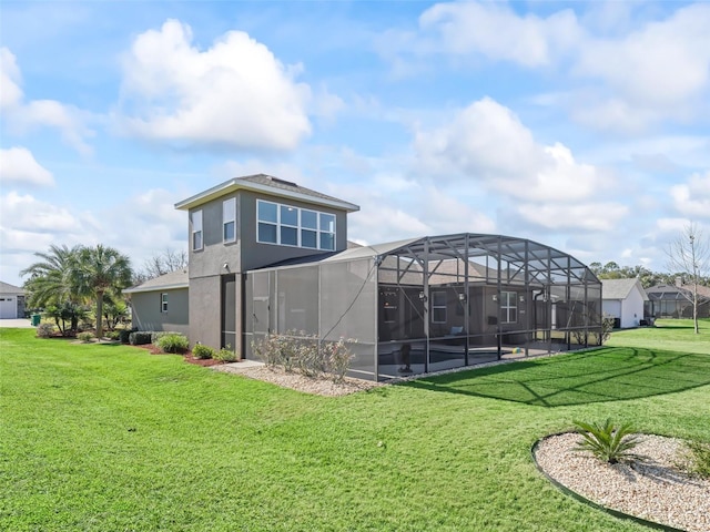 back of house with glass enclosure and a yard