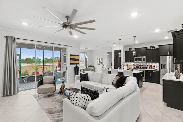 living room with crown molding and ceiling fan