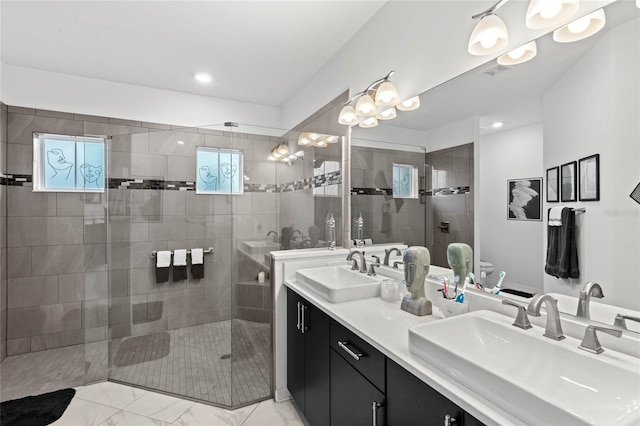 bathroom with vanity, a wealth of natural light, and walk in shower