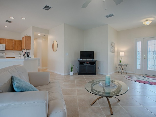 tiled living room featuring ceiling fan