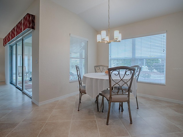 tiled dining room with plenty of natural light, a notable chandelier, and vaulted ceiling