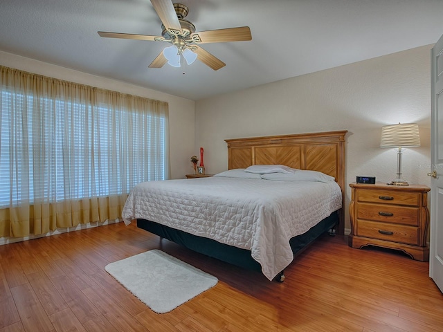 bedroom with ceiling fan and light wood-type flooring