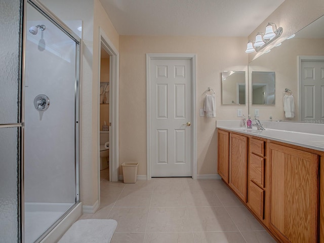 bathroom featuring tile patterned floors, walk in shower, toilet, and vanity