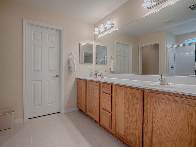 bathroom with vanity, tile patterned flooring, and a shower with door