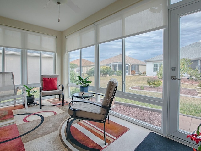 sunroom featuring ceiling fan and a wealth of natural light