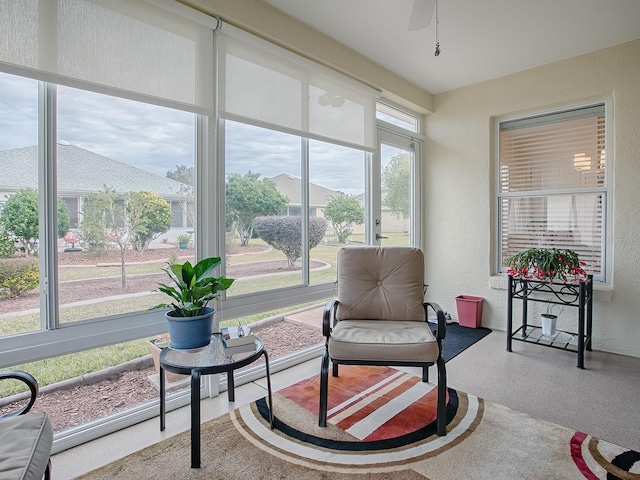 sunroom / solarium featuring ceiling fan