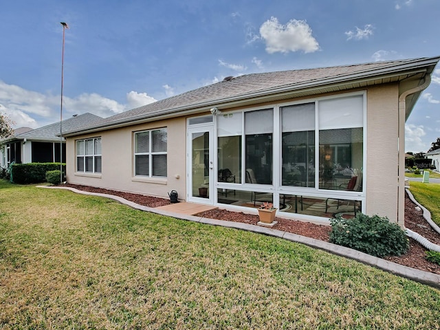 rear view of property with a lawn