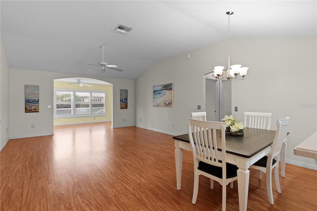 unfurnished dining area with lofted ceiling, hardwood / wood-style flooring, and ceiling fan with notable chandelier