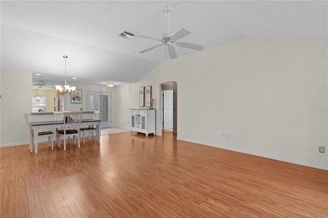 living room featuring lofted ceiling, light hardwood / wood-style floors, and ceiling fan with notable chandelier