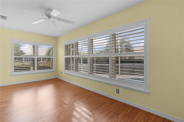 empty room with ceiling fan and light wood-type flooring