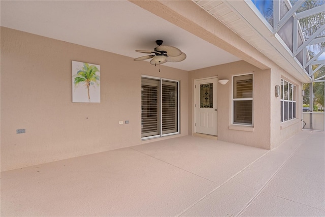 view of patio / terrace with ceiling fan and glass enclosure