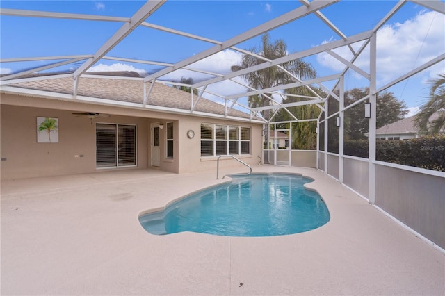 view of pool featuring a patio, ceiling fan, and glass enclosure