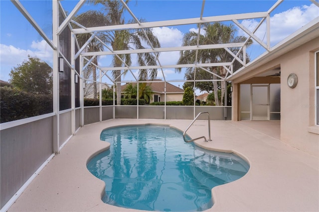 view of pool featuring a patio area and glass enclosure